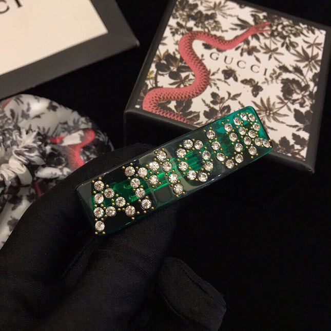 GUCCI 26S CRYSTAL LOGO HAIR CLIP IN GREEN RESIN AND GOLD TONE METAL