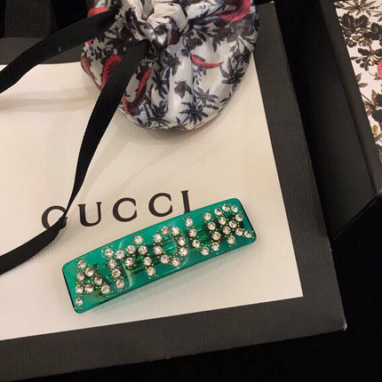 GUCCI 26S CRYSTAL LOGO HAIR CLIP IN GREEN RESIN AND GOLD TONE METAL