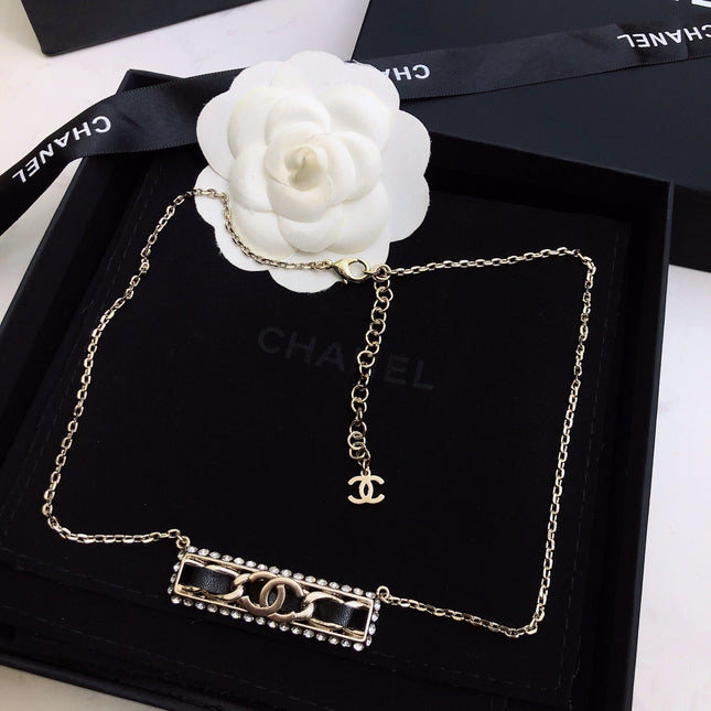 CHANEL 26S CHANEL CC LOGO CRYSTAL TRIM BAR PENDANT NECKLACE WITH BLACK LEATHER IN GOLD METAL 633315
