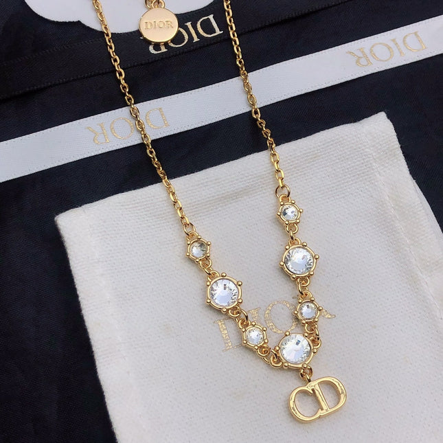 CD 26S CD LOGO CRYSTAL STATION NECKLACE IN GOLD TONE METAL WITH WHITE CRYSTAL 631006