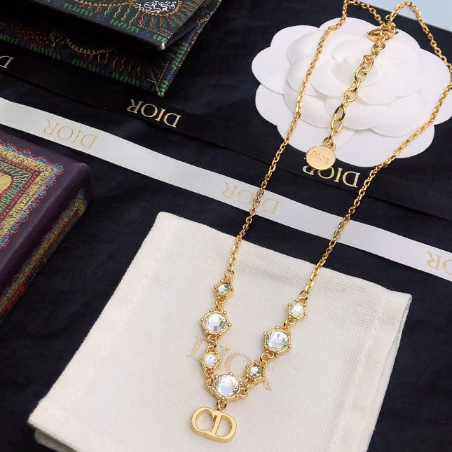CD 26S CD LOGO CRYSTAL STATION NECKLACE IN GOLD TONE METAL WITH WHITE CRYSTAL 631006