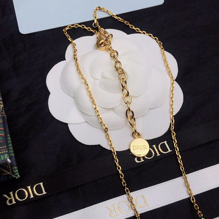 CD 26S CD LOGO CRYSTAL STATION NECKLACE IN GOLD TONE METAL WITH WHITE CRYSTAL 631006