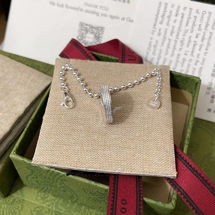 GUCCI 26S INTERLOCKING G LOGO CRYSTAL DISC PENDANT NECKLACE IN SILVER TONE METAL