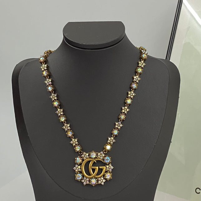 GUCCI 26S INTERLOCKING GG CRYSTAL FLORAL LINK NECKLACE IN ANTIQUE GOLD TONE METAL 620394