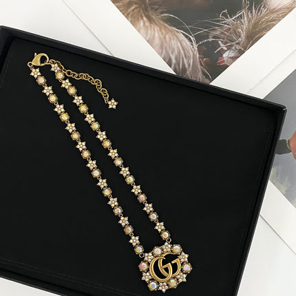 GUCCI 26S INTERLOCKING GG CRYSTAL FLORAL LINK NECKLACE IN ANTIQUE GOLD TONE METAL 620394