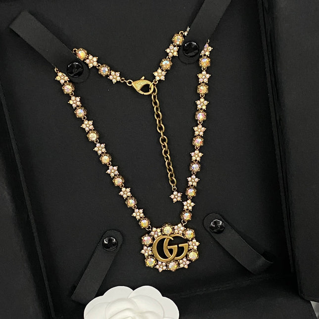 GUCCI 26S INTERLOCKING GG CRYSTAL FLORAL LINK NECKLACE IN ANTIQUE GOLD TONE METAL 620394