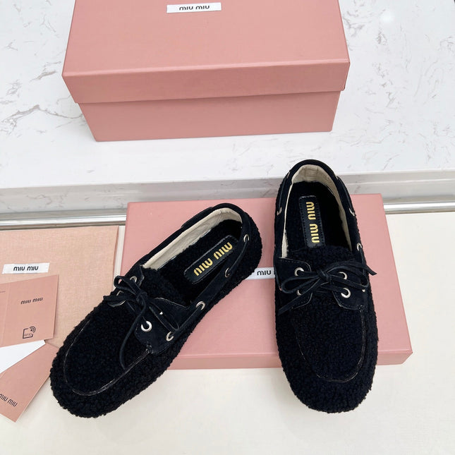MIUMIU 26S BOAT LOAFERS IN BLACK SHEARLING