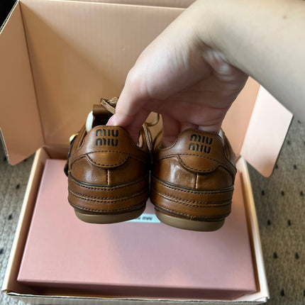 MIUMIU 26S GYMNASIUM SNEAKER IN COGNAC BROWN CALFSKIN WITH GOLD BUCKLED STRAP