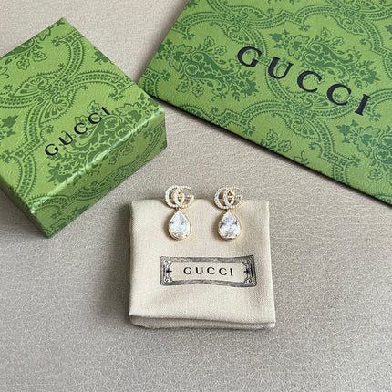 GUCCI 26S INTERLOCKING GG MINI CRYSTAL TEARDROP EARRINGS IN GOLD TONE METAL 620512