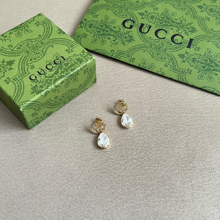 GUCCI 26S INTERLOCKING GG MINI CRYSTAL TEARDROP EARRINGS IN GOLD TONE METAL 620512