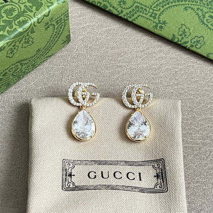 GUCCI 26S INTERLOCKING GG MINI CRYSTAL TEARDROP EARRINGS IN GOLD TONE METAL 620512