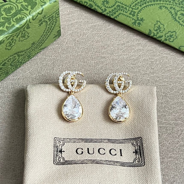 GUCCI 26S INTERLOCKING GG MINI CRYSTAL TEARDROP EARRINGS IN GOLD TONE METAL 620512