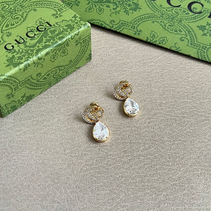 GUCCI 26S INTERLOCKING GG MINI CRYSTAL TEARDROP EARRINGS IN GOLD TONE METAL 620512