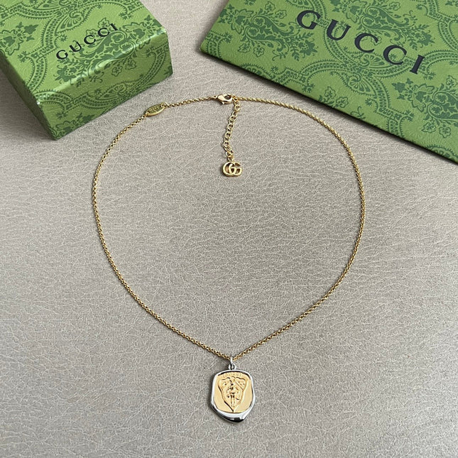 GUCCI 26S EMBLEM SHIELD PENDANT NECKLACE IN GOLD AND SILVER TONE METAL 625551