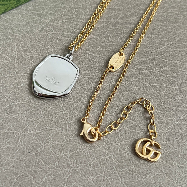 GUCCI 26S EMBLEM SHIELD PENDANT NECKLACE IN GOLD AND SILVER TONE METAL 625551