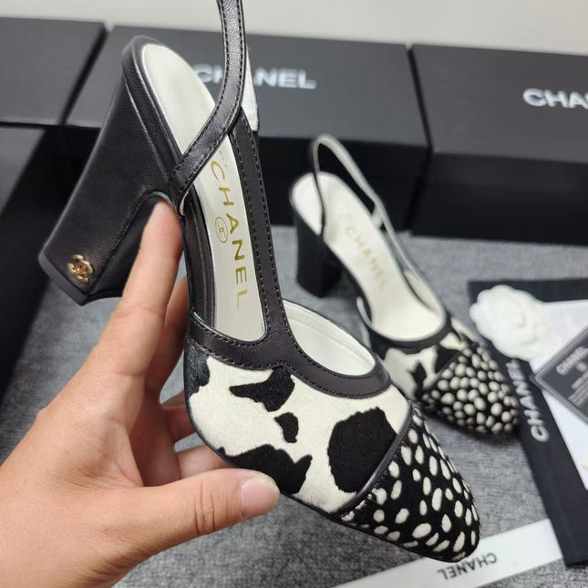 CHANEL SLINGBACK HEELS IN BLACK AND WHITE COW PRINT