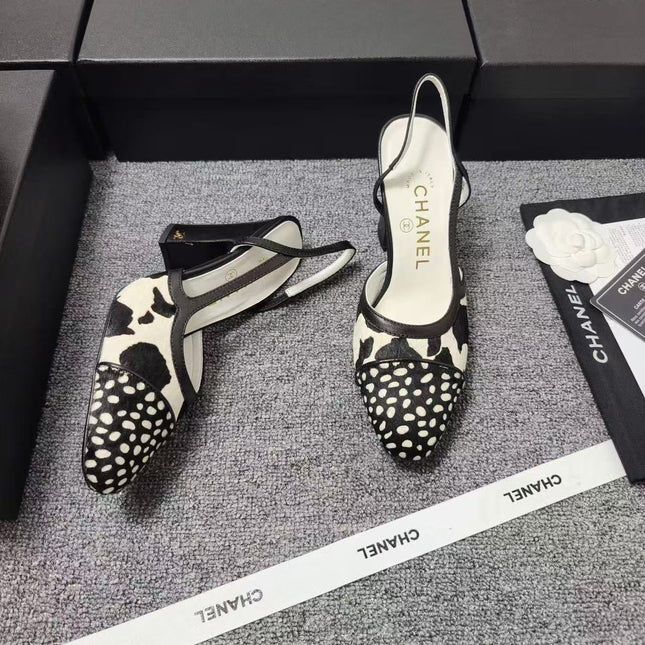 CHANEL SLINGBACK HEELS IN BLACK AND WHITE COW PRINT
