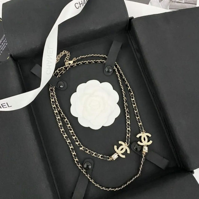 GOLD-TONE CHANEL CHAIN BELT WITH BLACK ENAMEL AND CRYSTAL-ENCRUSTED INTERLOCKING CC CHARMS