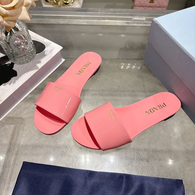 PRADA 26S LOGO EMBOSSED SLIDE SANDALS IN PINK PATENT CALFSKIN