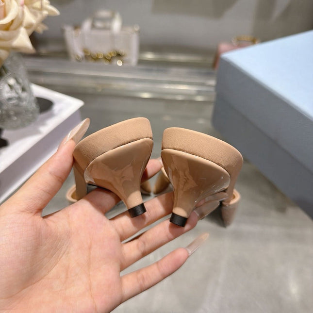 PRADA 26S LOGO EMBOSSED KITTEN HEEL MULES IN NUDE BEIGE PATENT CALFSKIN