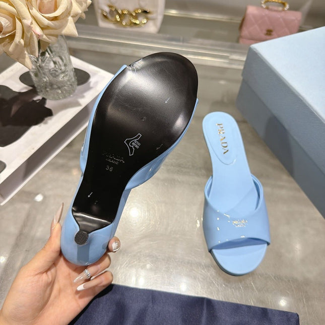 PRADA 26S LOGO EMBOSSED KITTEN HEEL MULES IN SKY BLUE PATENT CALFSKIN