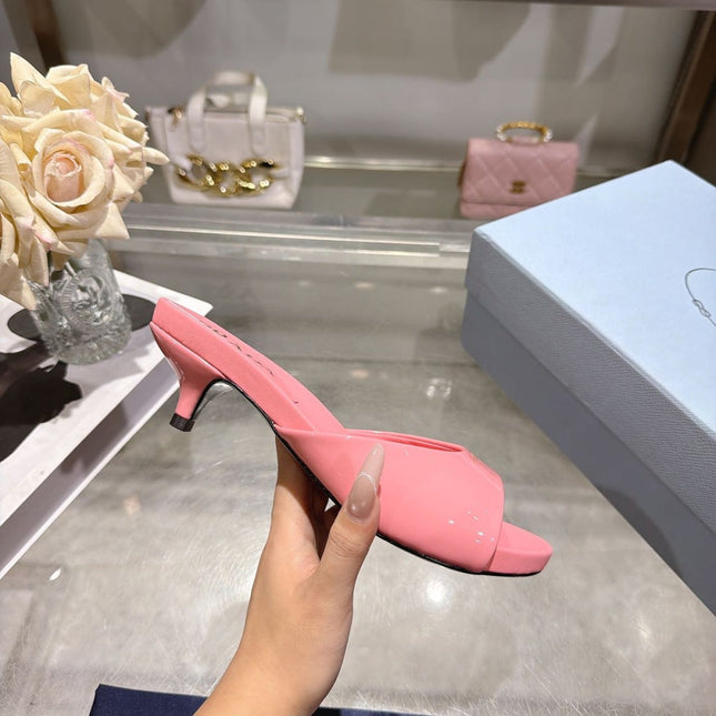PRADA 26S LOGO EMBOSSED KITTEN HEEL MULES IN PINK PATENT CALFSKIN