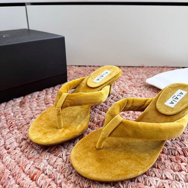 ALAIA 26S HEELED THONG SANDALS IN MUSTARD YELLOW VELVET