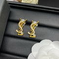 YSL 26S STUDDED CRYSTAL PEARL LOGO EARRINGS IN GOLD TONE METAL 629138