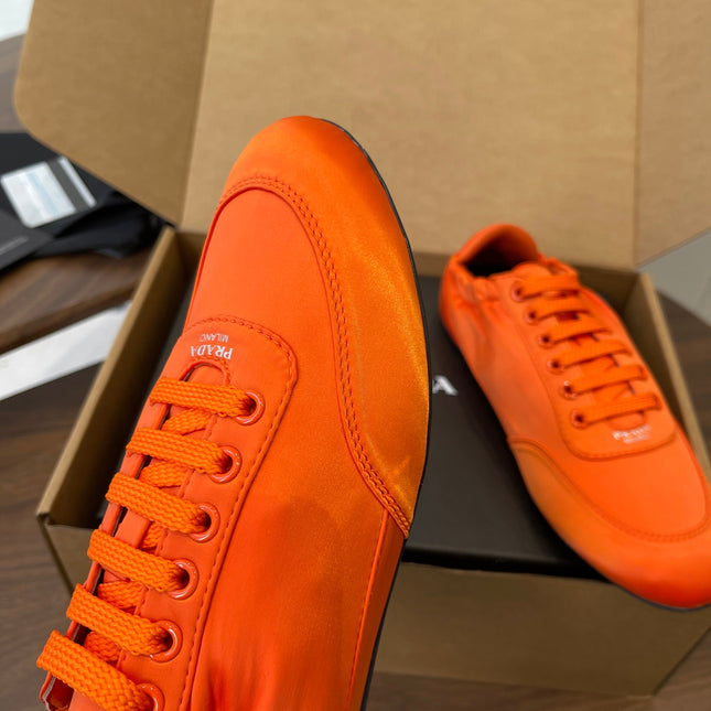 PRADA 25S SNEAKER IN ORANGE SILK