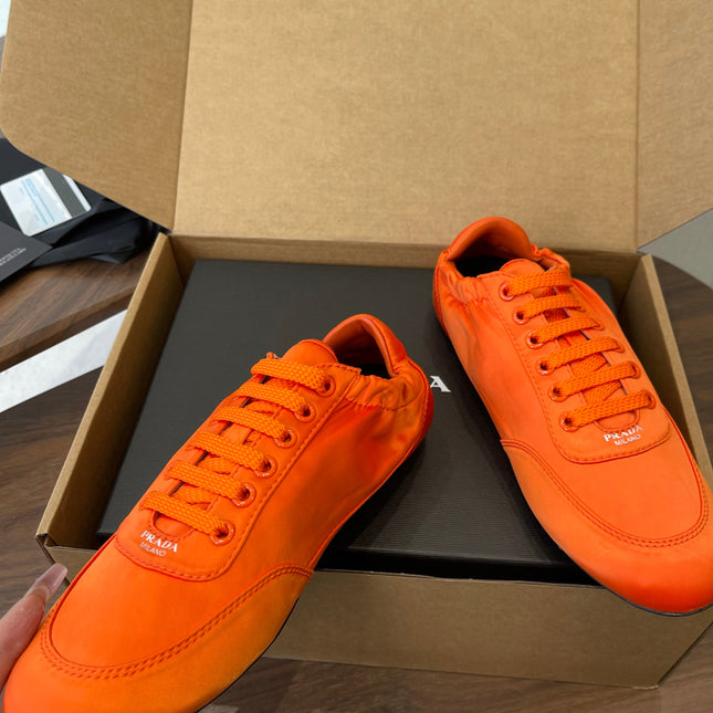 PRADA 25S SNEAKER IN ORANGE SILK