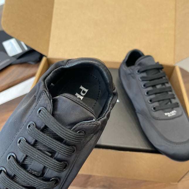PRADA 25S SNEAKER IN BLACK SILK