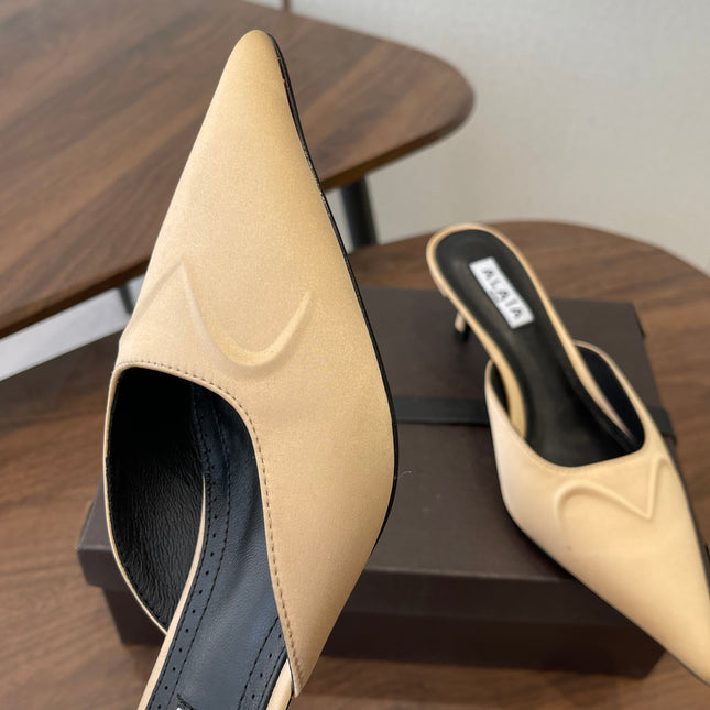 ALAIA 26S HEELED MULES 50 MM IN WARM BEIGE FABRIC
