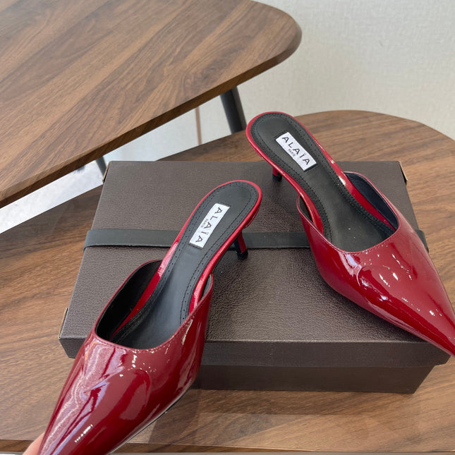ALAIA 26S HEELED MULES 50 MM IN DARK RED GLOSSY CALFSKIN