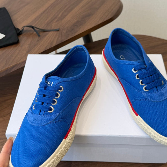 CELINE 26S TRIOMPHE LOW TOP SNEAKERS IN BLUE CANVAS RED TRIM