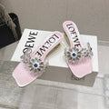LOEWE 26S MULE HEELS 45MM IN LIGHT PINK PVC WITH CRYSTAL FLORAL