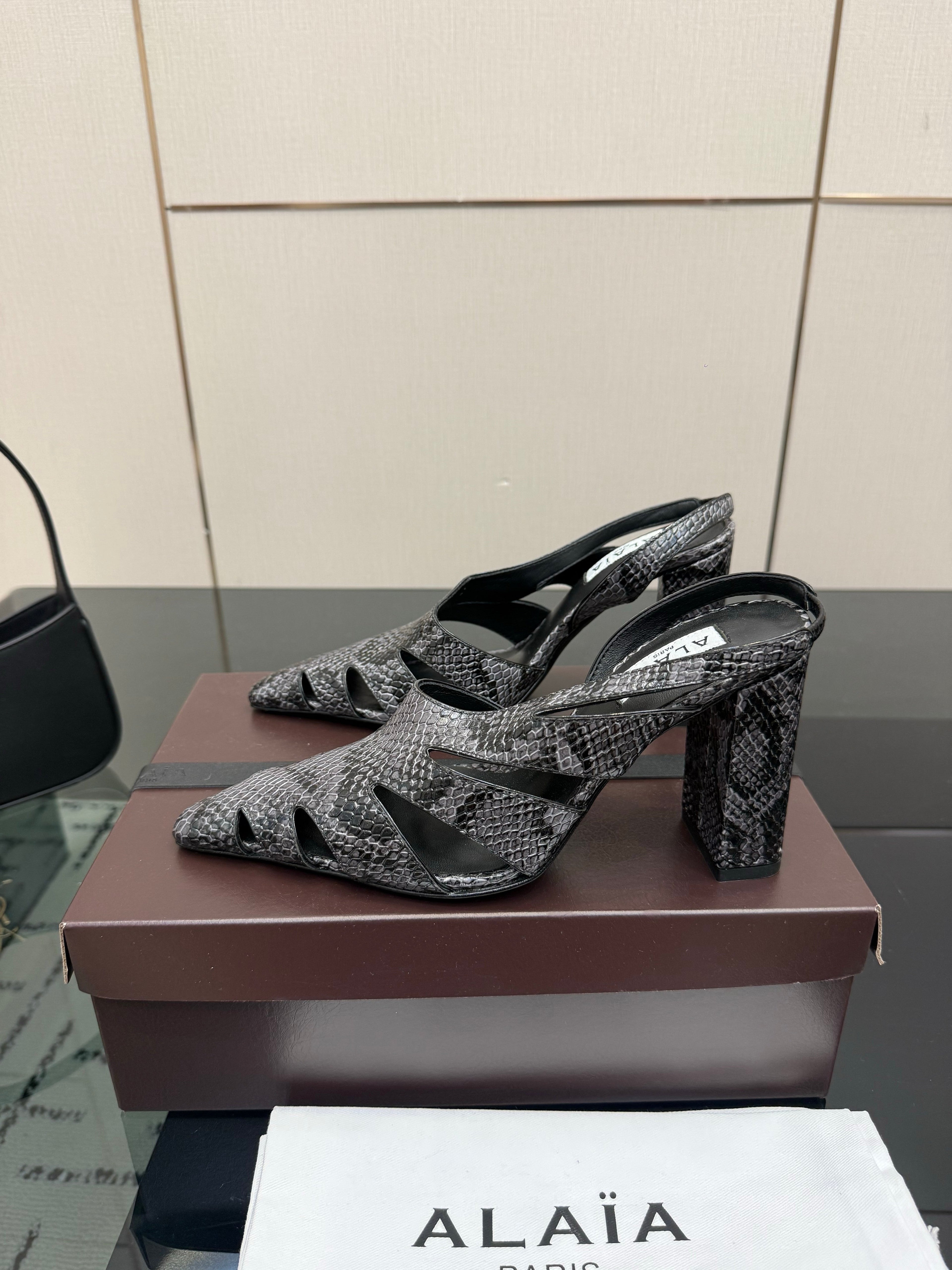 ALAIA 26S HEELED SLINGBACKS IN BLACK PYTHON-EMBOSSED LEATHER