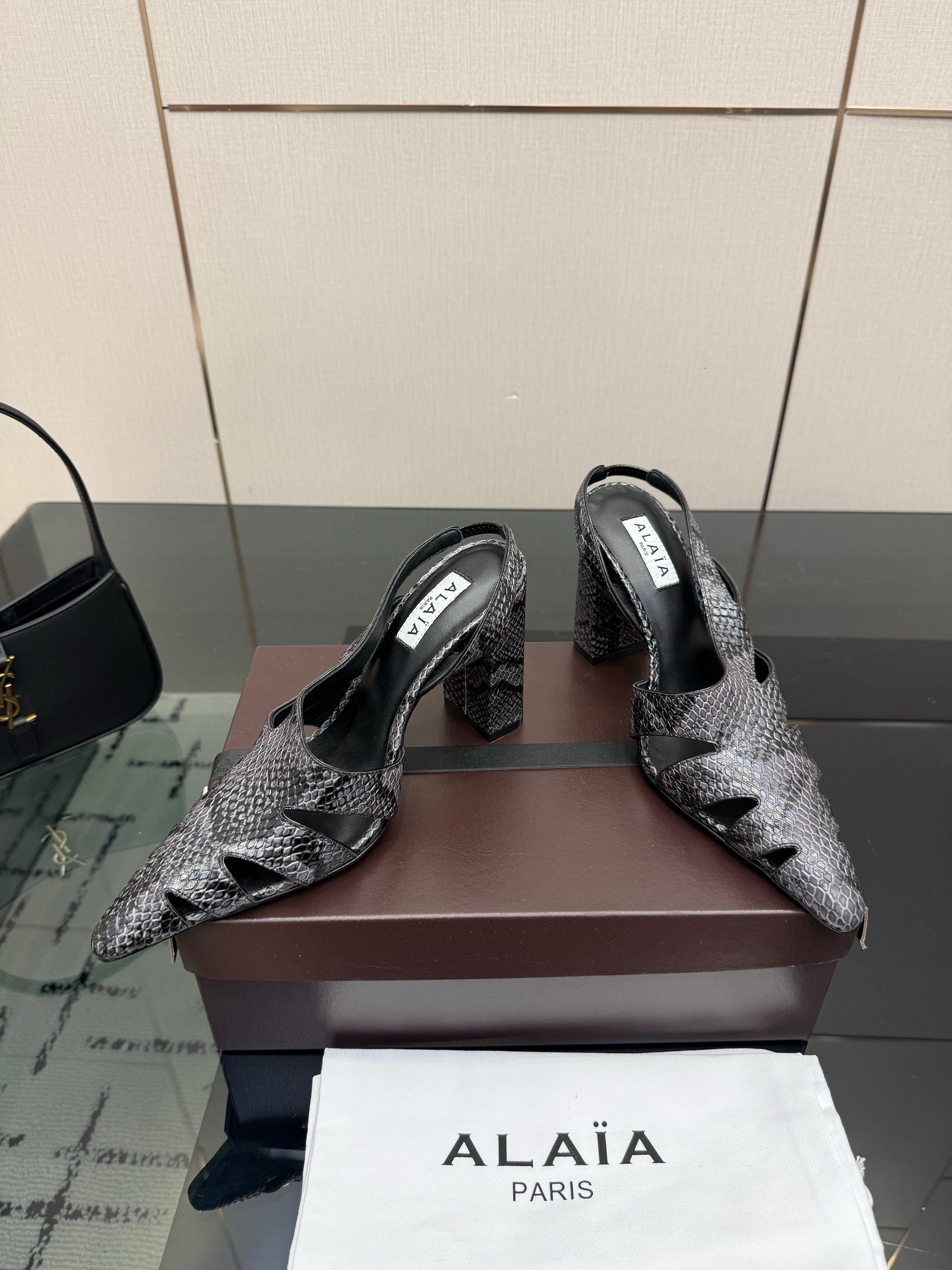 ALAIA 26S HEELED SLINGBACKS IN BLACK PYTHON-EMBOSSED LEATHER