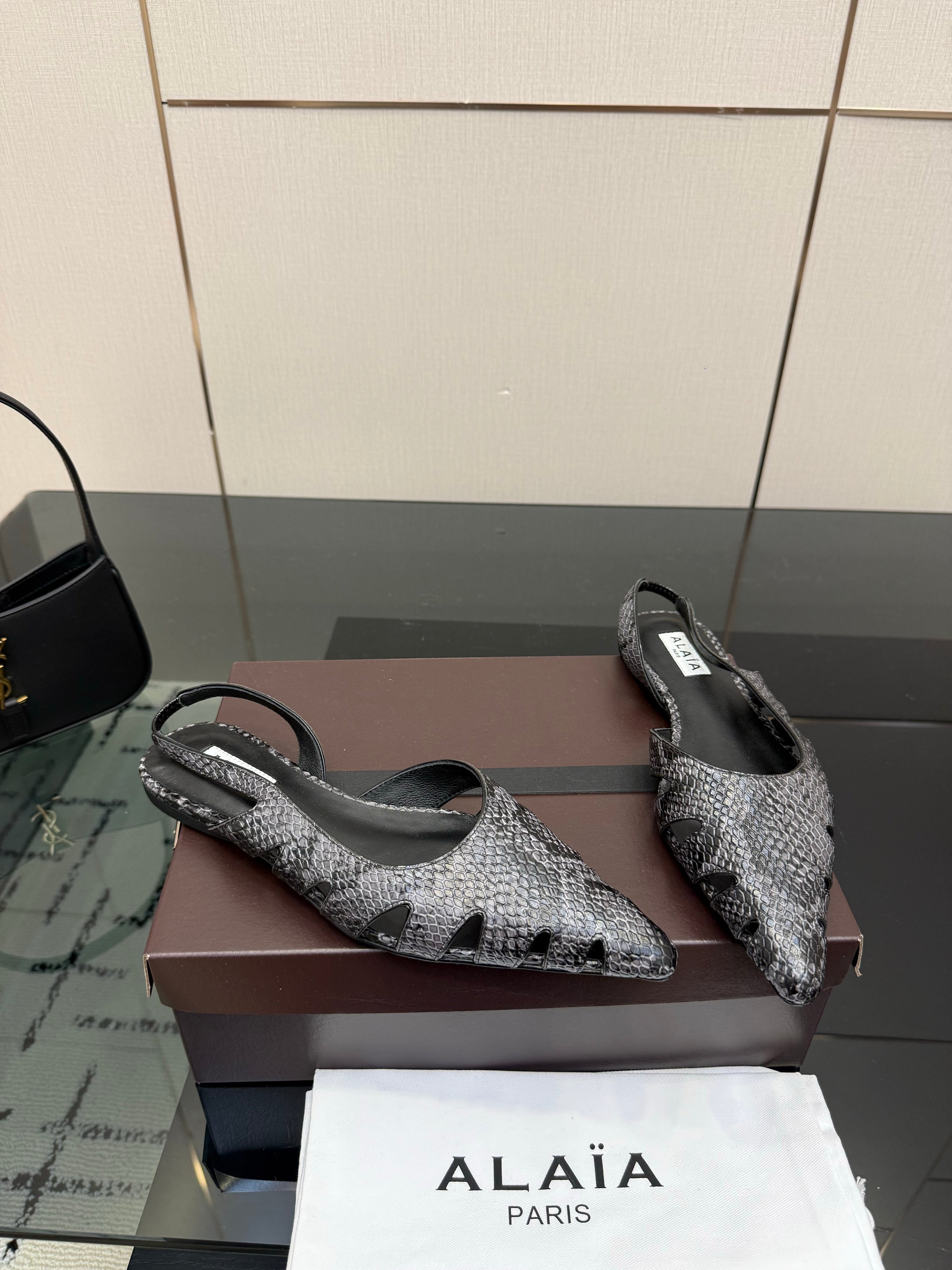 ALAIA 26S CUT-OUT SLINGBACK FLATS IN BLACK PYTHON-EMBOSSED LEATHER