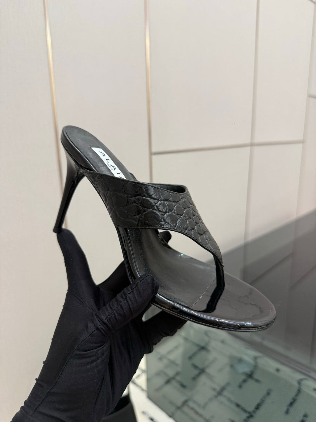 ALAIA 26S HEELED THONG MULE SANDALS IN BLACK CALFSKIN