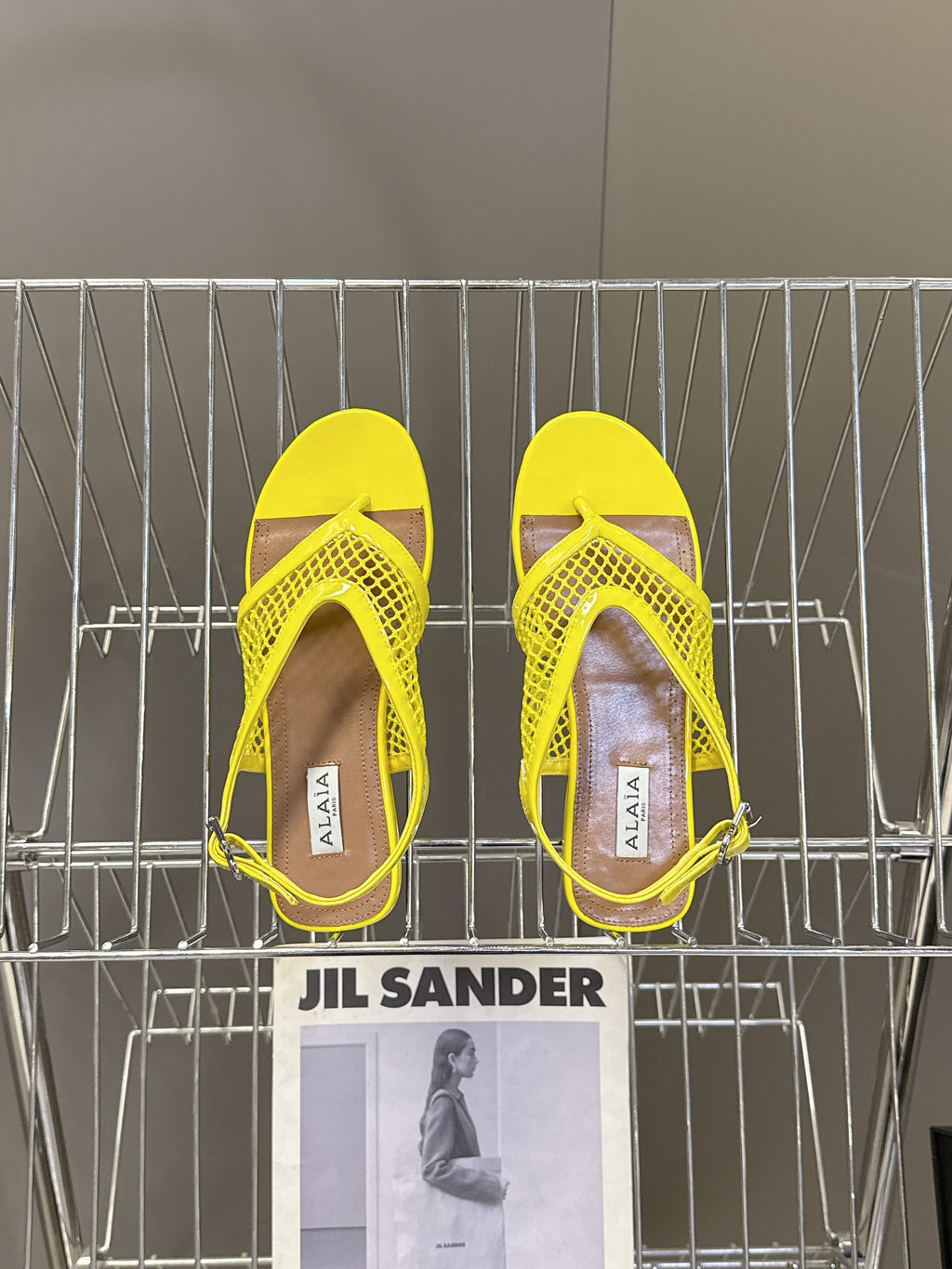 ALAIA 26S FLAT MESH THONG SANDALS IN YELLOW PATENT CALFSKIN