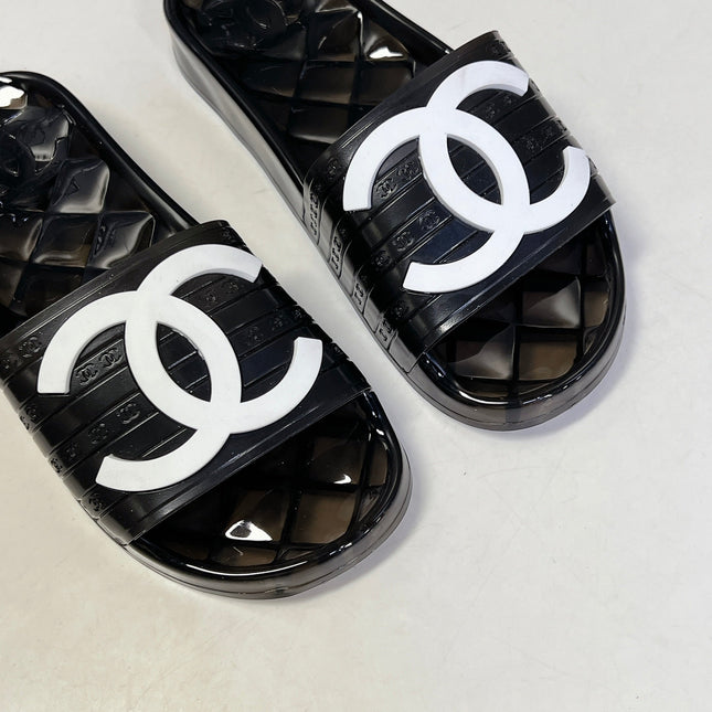 CHANEL 26S SLIDES IN BLACK PVC WITH WHITE LOGO