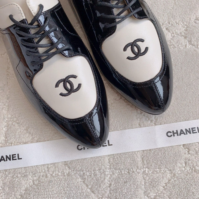 CHANEL 25S TWO TONE LACE UP IN BLACK AND WHITE SHINY CALFSKIN