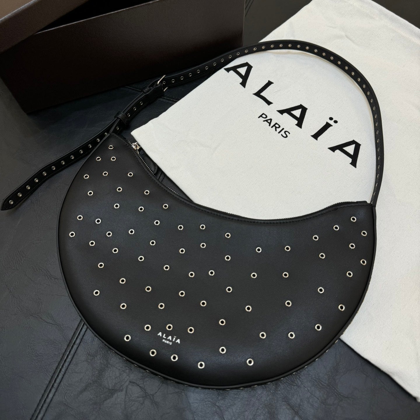 ONE PIECE DEMI LUNE BAG 31 IN BLACK SHEEPSKIN EYELET DETAILING