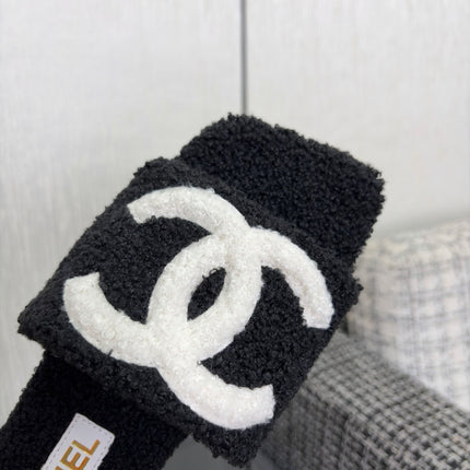 CHANEL 26S SLIDE SANDALS IN BLACK SHEARLING AND WHITE CC LOGO SQUARE TOE