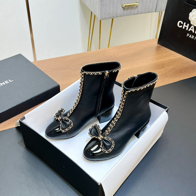 CHANEL 25S HEELED CHAIN BOOTS WITH BOW IN BLACK CALFSKIN GOLD HARDWARE