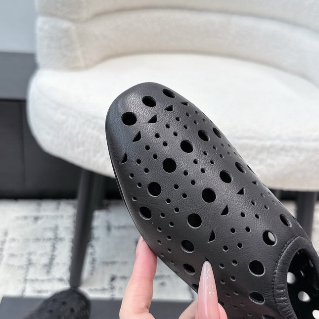 ALAIA 26S FLAT SLIP-ONS IN BLACK CALFSKIN WITH OPENWORK PATTERN