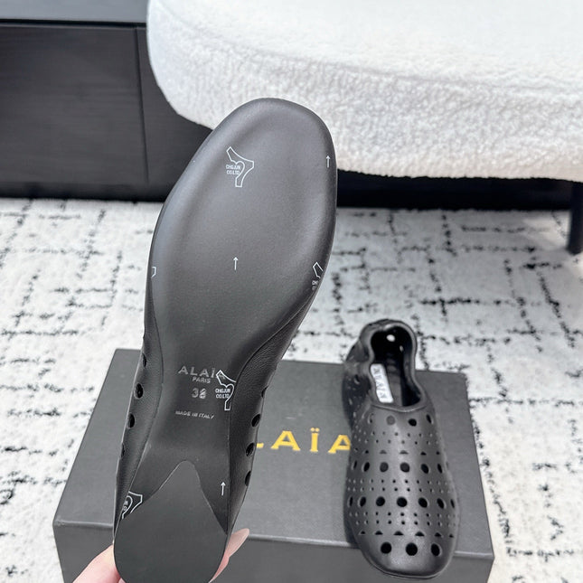 ALAIA 26S FLAT SLIP-ONS IN BLACK CALFSKIN WITH OPENWORK PATTERN