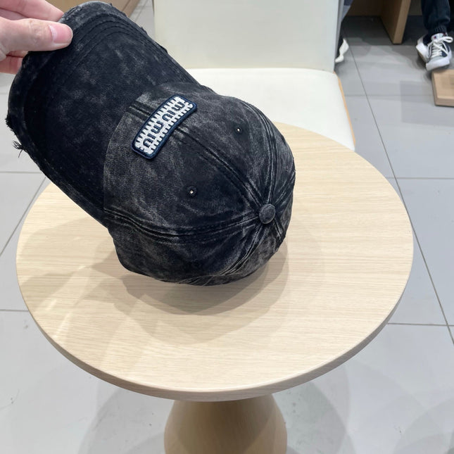 MIUMIU DISTRESSED FABRIC BASEBALL CAP IN BLACK WITH EMBROIDERED LOGO
