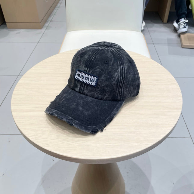 MIUMIU DISTRESSED FABRIC BASEBALL CAP IN BLACK WITH EMBROIDERED LOGO
