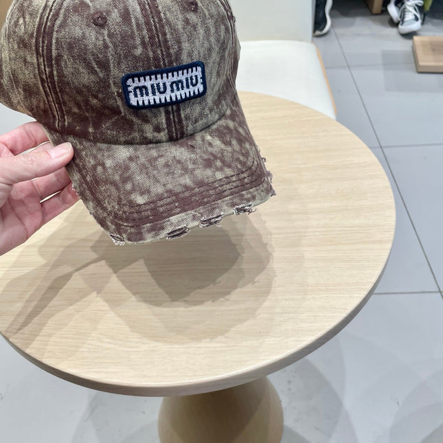MIUMIU DISTRESSED FABRIC BASEBALL CAP IN BROWN WITH EMBROIDERED LOGO